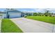 Well-maintained home exterior featuring a long driveway, and lush lawn at 1769 Brookside Blvd, Largo, FL 33770