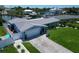 Charming home with an attached garage, well-maintained landscaping, and a spacious driveway, showcasing suburban living at 1769 Brookside Blvd, Largo, FL 33770