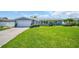 Charming home with a lush green lawn, colorful landscaping, and a welcoming entrance, showcasing curb appeal at 1769 Brookside Blvd, Largo, FL 33770