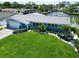 Beautiful waterfront home featuring a manicured lawn, lush landscaping, and a private boat dock, perfect for outdoor living at 1769 Brookside Blvd, Largo, FL 33770