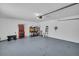 Spacious garage featuring an epoxy floor, overhead lighting, and ample storage and workspace for tools and equipment at 1769 Brookside Blvd, Largo, FL 33770