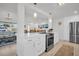 Modern kitchen boasts white cabinets, stainless steel appliances, and an island with countertop seating at 1769 Brookside Blvd, Largo, FL 33770