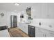 Bright kitchen featuring white cabinets, stainless steel appliances, and quartz countertops at 1769 Brookside Blvd, Largo, FL 33770