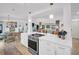 Bright open-concept kitchen features white cabinets, stainless steel appliances, and quartz countertops at 1769 Brookside Blvd, Largo, FL 33770