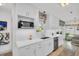 Modern kitchen with white cabinetry, stainless steel appliances, and a view to the dining area at 1769 Brookside Blvd, Largo, FL 33770