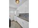 Modern laundry room with granite counters and ample cabinet space, providing convenience and style at 1769 Brookside Blvd, Largo, FL 33770