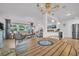 Bright open-concept living area with wood floors, dining table, modern kitchen, and comfortable seating at 1769 Brookside Blvd, Largo, FL 33770