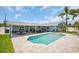 Beautiful backyard with a swimming pool, covered patio, and well-manicured lawn, ideal for outdoor relaxation and entertainment at 1769 Brookside Blvd, Largo, FL 33770
