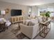 Comfortable living area with neutral tones, console table, woven accents and large windows at 1856 Draughton Dr, Zephyrhills, FL 33541