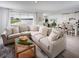 Open-concept living room featuring a large sectional sofa with lake views at 1856 Draughton Dr, Zephyrhills, FL 33541
