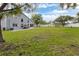 Extensive grassy backyard enclosed by a white vinyl fence with a paver patio at 1948 Grenville Ct, Wesley Chapel, FL 33543