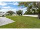 Spacious fenced-in backyard with lush green grass and paver patio, great for outdoor activities at 1948 Grenville Ct, Wesley Chapel, FL 33543