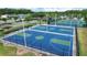 Aerial shot showcasing well-maintained community basketball courts with vibrant blue and green surfaces at 1948 Grenville Ct, Wesley Chapel, FL 33543