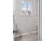 Bright bathroom featuring wood look floors and a window with natural light at 1948 Grenville Ct, Wesley Chapel, FL 33543
