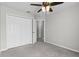 This bedroom has a double closet with plenty of storage and gray carpet at 1948 Grenville Ct, Wesley Chapel, FL 33543