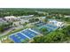 Aerial view of community amenities including pool, tennis courts, basketball courts and a commercial plaza at 1948 Grenville Ct, Wesley Chapel, FL 33543