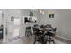 Bright dining area with wood floors, adjacent to the kitchen, offering seating for four at 1948 Grenville Ct, Wesley Chapel, FL 33543