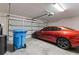 Spacious garage featuring a car and ample storage space with a modern garage door at 1948 Grenville Ct, Wesley Chapel, FL 33543