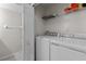 Laundry room with front-loading washer and dryer and wire shelving at 1948 Grenville Ct, Wesley Chapel, FL 33543