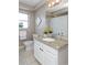 Bathroom featuring a granite countertop, white cabinets and modern fixtures at 2012 Scotland Dr, Clearwater, FL 33763