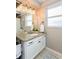 Bright bathroom with double sinks, granite countertop, and modern vanity lights at 2012 Scotland Dr, Clearwater, FL 33763