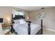 Cozy bedroom with a full-size bed, neutral color scheme and natural lighting at 2012 Scotland Dr, Clearwater, FL 33763