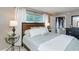 Well-lit bedroom featuring a large window with natural light and neutral color scheme with grey accents at 2012 Scotland Dr, Clearwater, FL 33763