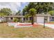Inviting home with a fresh exterior, mature landscaping, and a driveway leading to an attached garage at 2012 Scotland Dr, Clearwater, FL 33763