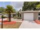 Charming single-story home features a well-manicured lawn, updated landscaping, and a one-car garage at 2012 Scotland Dr, Clearwater, FL 33763