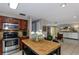Open-concept layout with kitchen island, stainless appliances, and seamless flow to the living area at 2012 Scotland Dr, Clearwater, FL 33763