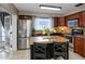 Well-equipped kitchen with stainless steel appliances, rich wood cabinets, and a convenient center island at 2012 Scotland Dr, Clearwater, FL 33763