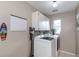 Functional laundry room with modern washer, dryer, and ample cabinet space at 2012 Scotland Dr, Clearwater, FL 33763