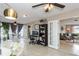 Bright living room featuring tile floors, ceiling fans, and versatile layout with dining area and adjacent living space at 2012 Scotland Dr, Clearwater, FL 33763