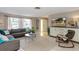 Cozy living room with ample natural light, tile floors, and a comfortable seating area at 2012 Scotland Dr, Clearwater, FL 33763