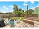 Backyard featuring a fire pit, outdoor seating, wooden benches, and a partial view of the home at 2306 Trelain S Dr, St Petersburg, FL 33712
