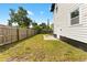 A fenced backyard with a grassy area and small patio, perfect for outdoor relaxation and entertaining at 2306 Trelain S Dr, St Petersburg, FL 33712