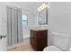 Bathroom featuring a tiled shower-tub, modern granite vanity, traditional fixtures, and ceramic tile flooring at 2306 Trelain S Dr, St Petersburg, FL 33712