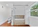 Bathroom featuring a tiled tub with grab bars, a toilet, and hardwood floors at 2306 Trelain S Dr, St Petersburg, FL 33712