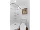 Bright bathroom features toilet and white tiled shower with built in shelves at 2306 Trelain S Dr, St Petersburg, FL 33712