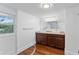 Bathroom featuring double sinks, a vanity, hardwood floors, and a large mirror at 2306 Trelain S Dr, St Petersburg, FL 33712