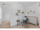 Cozy bedroom with a rocking chair, accent tables, decorative wall art and a crib; carpeted flooring throughout at 2306 Trelain S Dr, St Petersburg, FL 33712