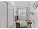 Bright bedroom featuring a window with natural light, a dresser, a closet and carpeted flooring throughout at 2306 Trelain S Dr, St Petersburg, FL 33712