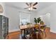 Inviting dining room with rustic wood table, industrial-style chairs, and a cozy window seat at 2306 Trelain S Dr, St Petersburg, FL 33712