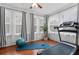 Bright exercise room with hardwood floors, multiple windows and a treadmill at 2306 Trelain S Dr, St Petersburg, FL 33712