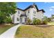 Charming two-story home with black and white accents, walkway and verdant lawn at 2306 Trelain S Dr, St Petersburg, FL 33712
