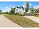 Two-story home features black and white accents, a driveway and front yard at 2306 Trelain S Dr, St Petersburg, FL 33712
