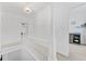 Bright white hallway with classic banister, decorative lighting, and open doorways creating an inviting, airy feel at 2306 Trelain S Dr, St Petersburg, FL 33712