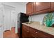 Kitchen area featuring granite countertops, wood cabinets, and stainless steel refrigerator at 2306 Trelain S Dr, St Petersburg, FL 33712