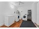 Laundry room featuring modern washer and dryer, freezer, shelving, and tile flooring at 2306 Trelain S Dr, St Petersburg, FL 33712