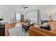 Bright living room with hardwood floors, ceiling fan, area rug and lots of natural light at 2306 Trelain S Dr, St Petersburg, FL 33712